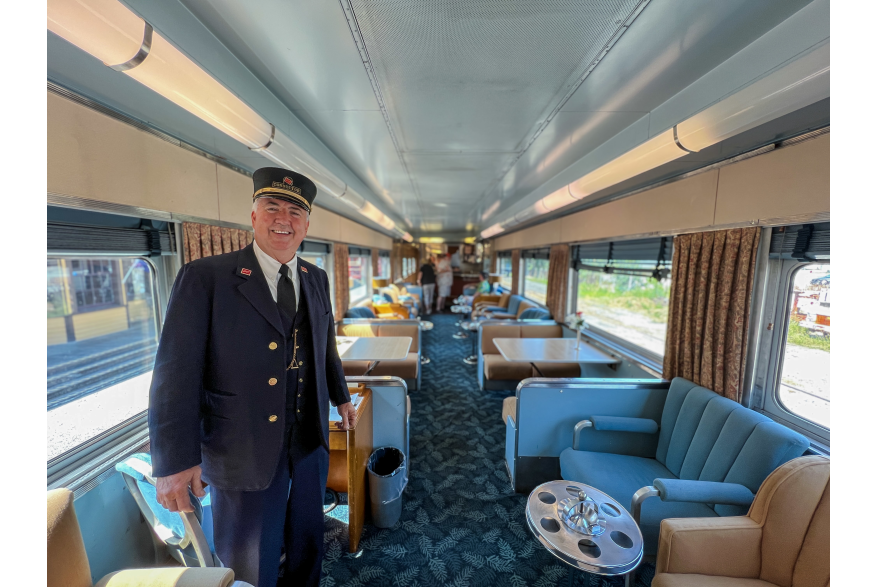train conductor inside one of the twin sisters train cars at Northern Central Railway