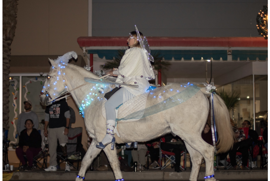 Women from Saddles of Joy dress as aurora from Disney's Maleficent on top of her horse with matching attire