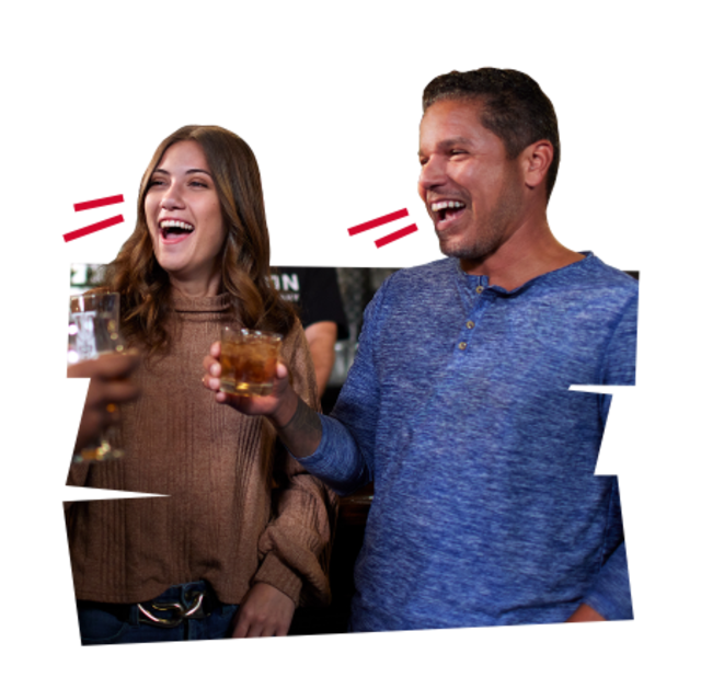 Couple with drinks exclaiming