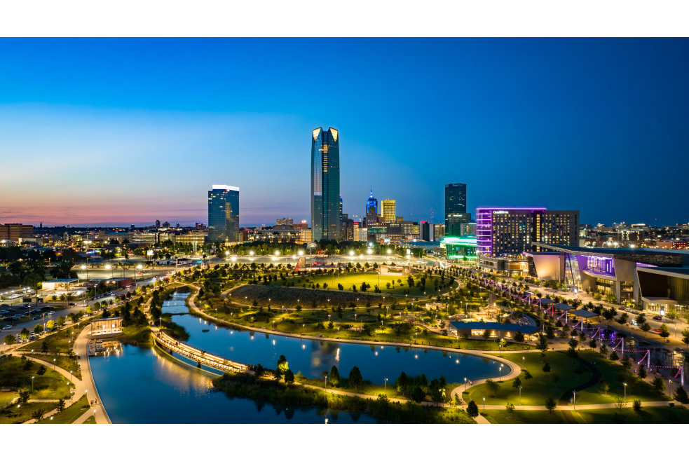 Skyline photo of downtown OKC that captures Scissortail Park at night