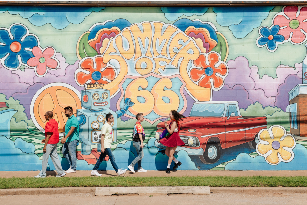 People walking in front of Summer of 66 Mural