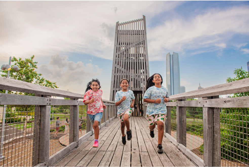 3 kids running at the playground at Scissortail Park in Oklahoma City