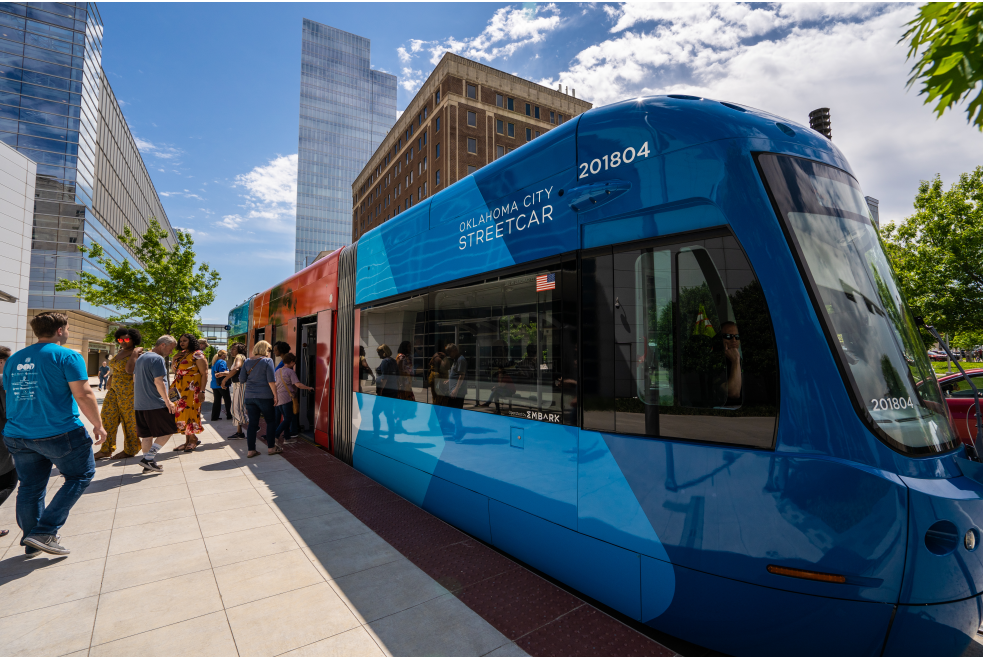 Groups entering and exiting Thunder-themed OKC Streetcar at route stop in downtown Oklahoma City