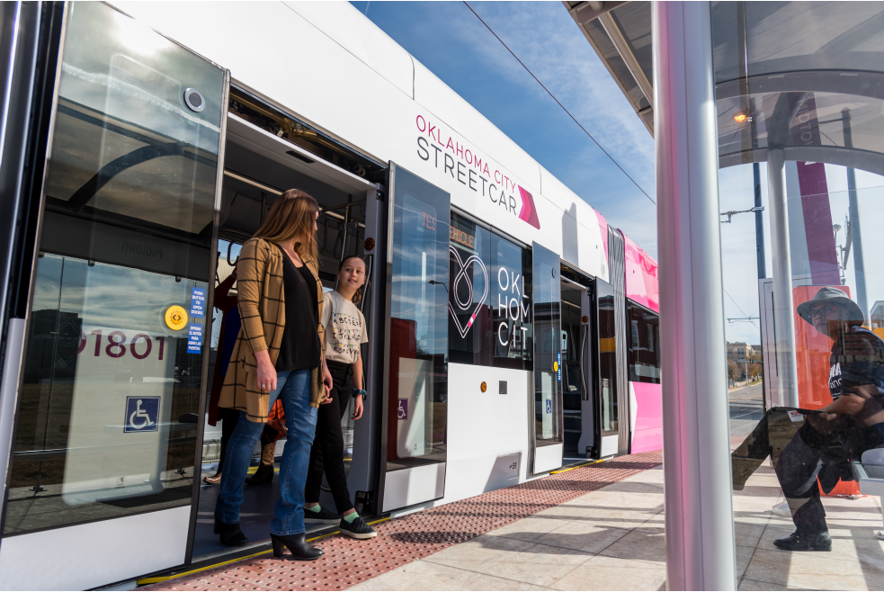 Women exiting pink OKC Streetcar at route stop in downtown Oklahoma City