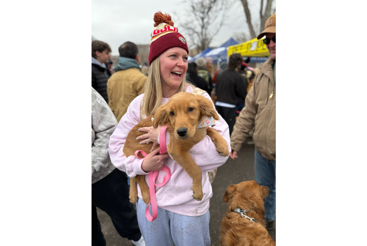 A golden retriever puppy and owner at Goldens in Golden in downtown Golden CO 2025