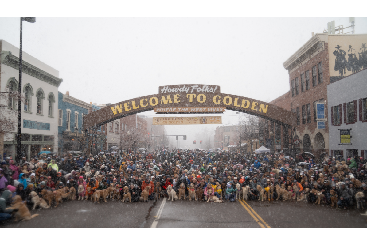 Group photo under Welcome to Golden arch at Goldens in Golden event
