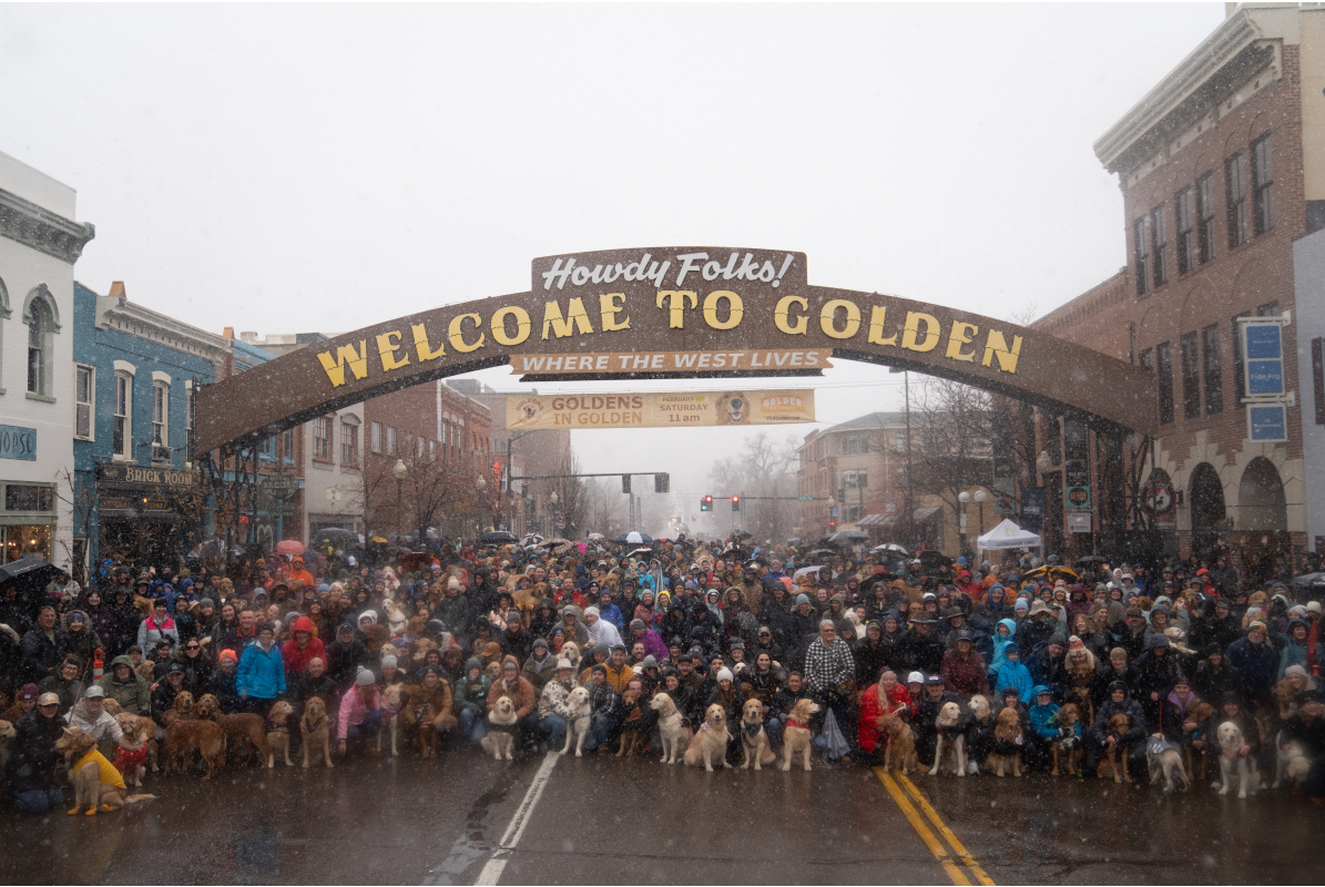 Group Photo Under Welcome to Golden Arch for Goldens in Golden event