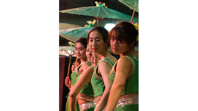 Asian girls performing with umbrellas