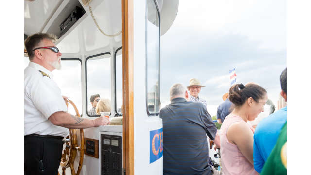 The captain and crowd on the Charles River Cruise