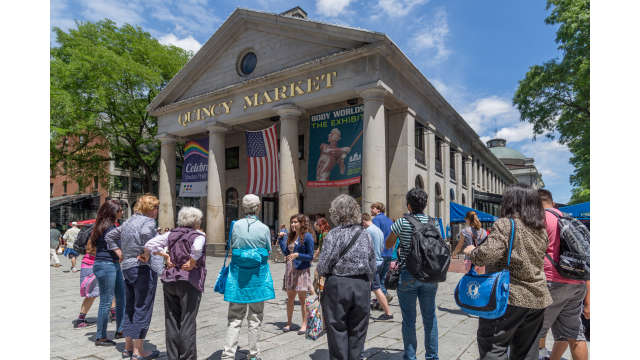 A tour hosted by Boston by Foot makes a stop at Quincy Market
