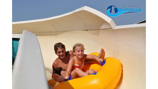 boy and girl riding a tube down the water slide at Gulf Islands Water Park