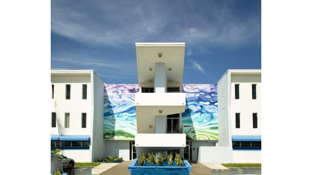Photo of Public Artwork, colorful wave mural on the front of the Amman Building.