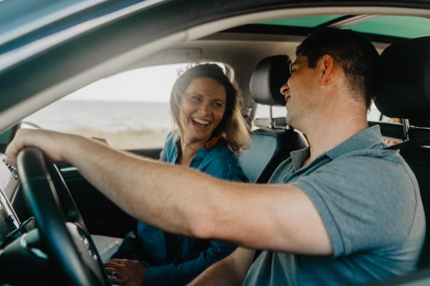 A Man and Woman Driving Along Beach Boulevard