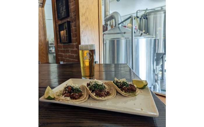 Chili Colorado Tacos with one of our crisp, hoppy Anniversary Pilsners