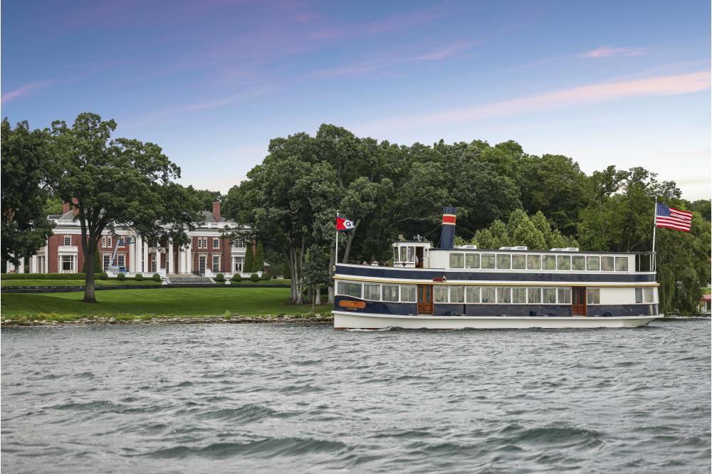 Grand Belle of Geneva in front of large estate on Lake Geneva