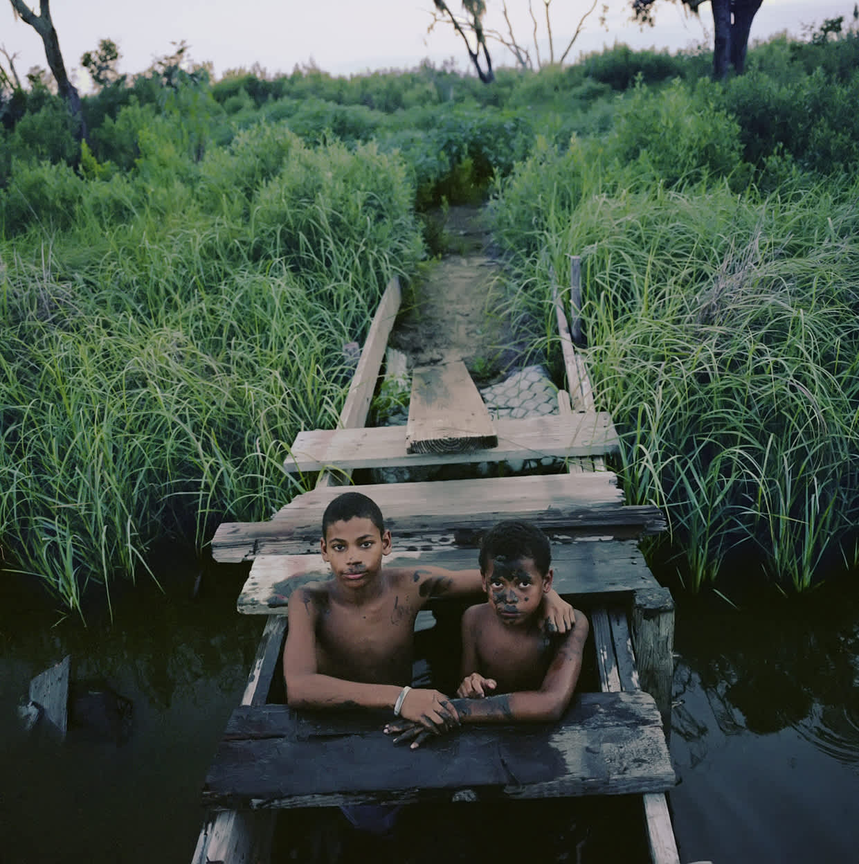 Kael Alford, Joseph and Jasmon Jackson play in the bayou, Isle de Jean Charles, LA, 2010, 14 x 14 inches, Gift of Edwin Robinson, 2018.11.7