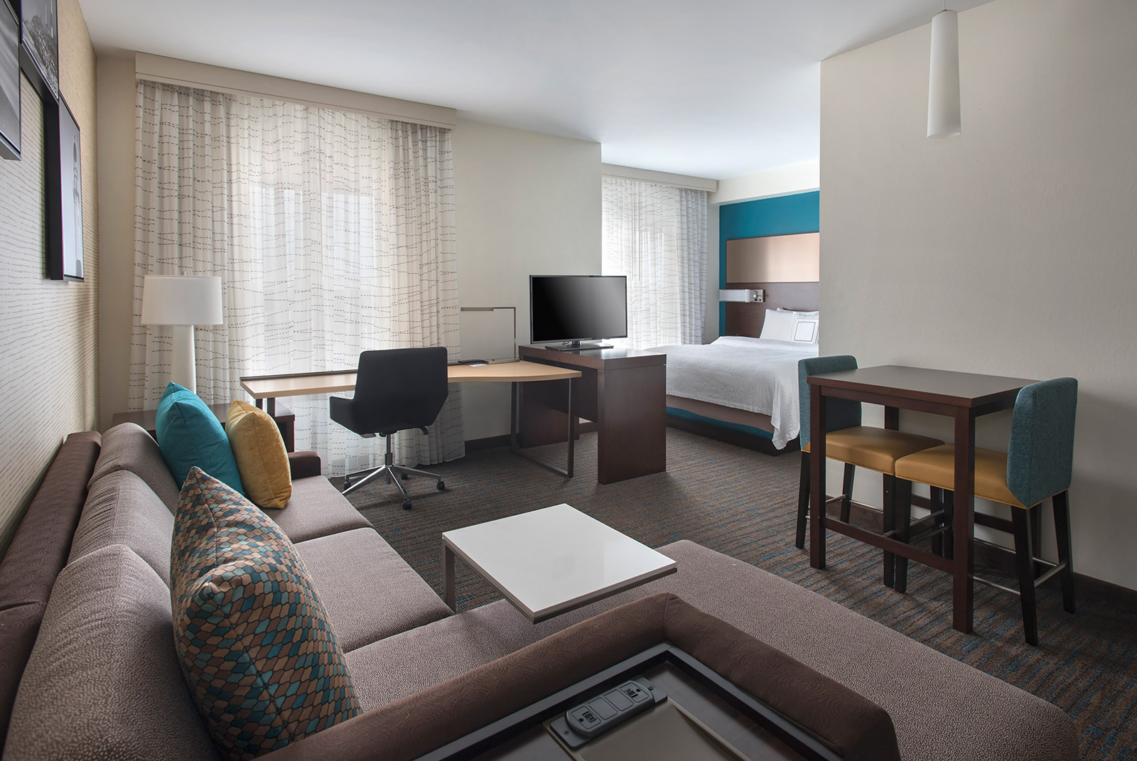 King Studio Suite - The studio suites feature separate living and sleeping areas, full-size kitchens, pull-out sofas and ergonomic work spaces for staying productive in style.