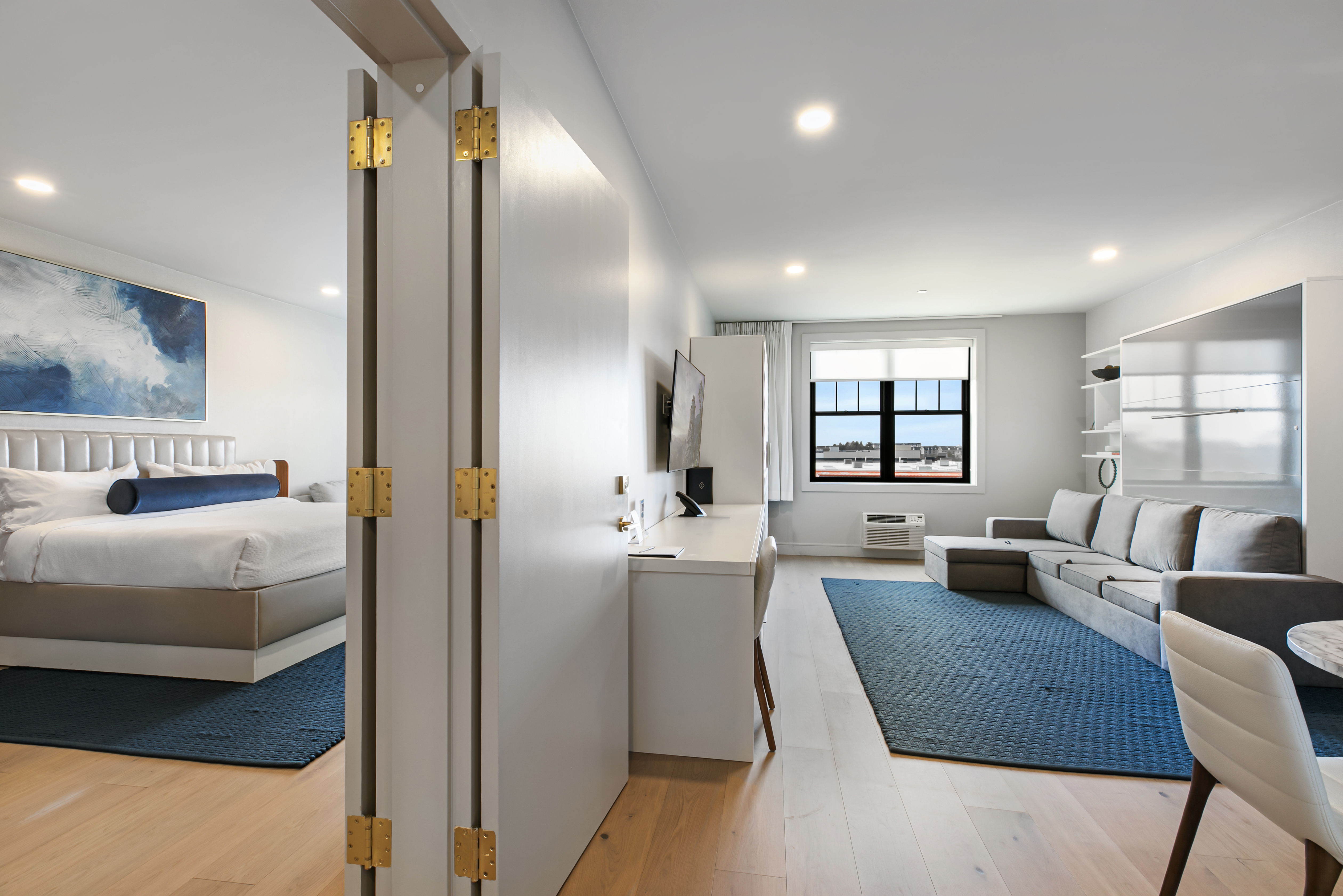 One Bedroom Executive Suite - One Bedroom Suites (1020 sq. ft.) at The Selby offer comfort and convenience, featuring a private bedroom with a king size bed. The separate living area offers a cozy couch that converts into a sleeper, perfect for extra guests, along with two full baths for added privacy. Complete with a kitchenette, in-suite washer and dryer, and all the comforts of home, this suite is ideal for extended stays and getaways.