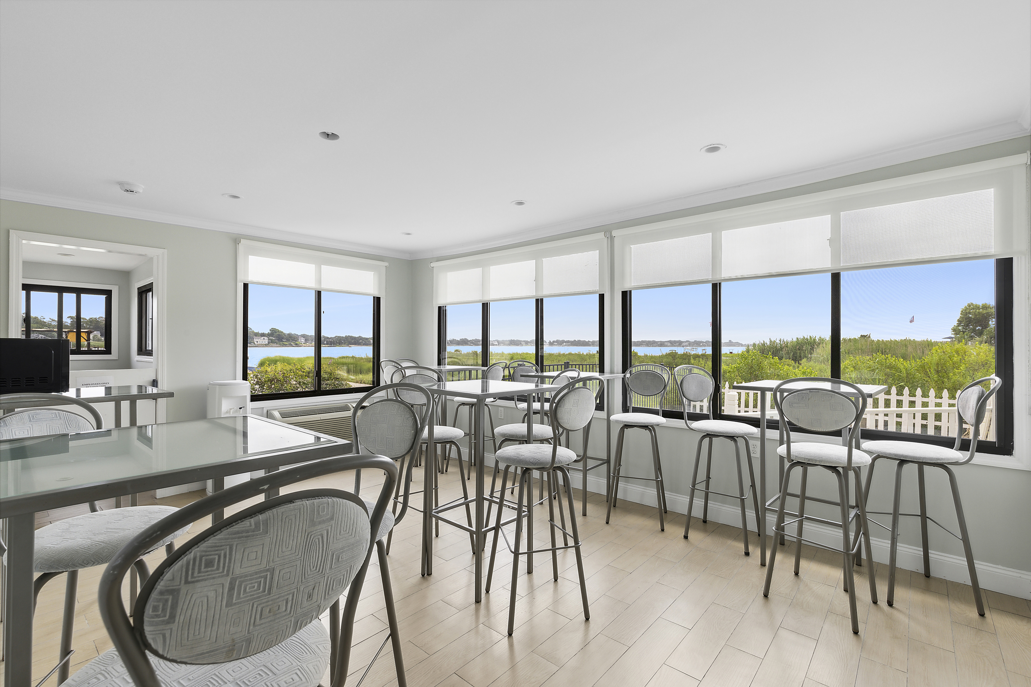 Amenities - Dining Room - Once you grabbed your breakfast goodies from our continental selection, enjoy your selections in our beautiful dining room! Fitted with high top chairs and tables, soak in the beautiful morning sun and Tiana Bay views from our South facing windows.