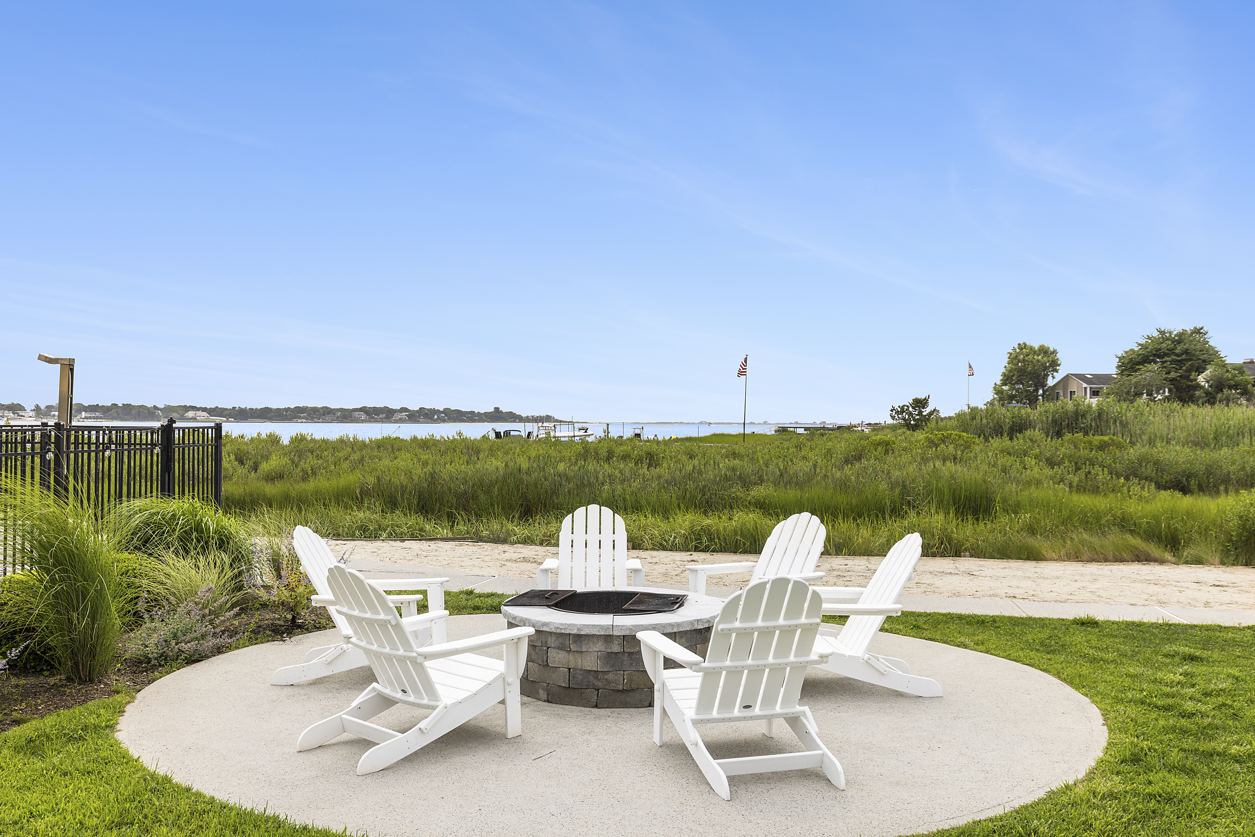 Waterfront Amenities - Firepit - Our fire pit, which is fitted with adirondack chairs, truly captures the beautiful south facing views of Tiana Bay!