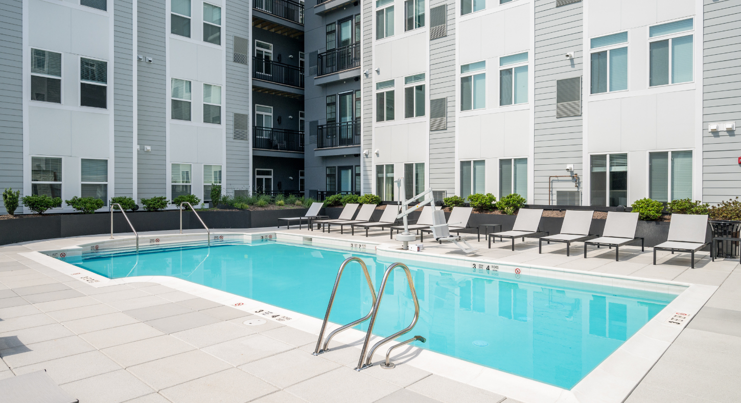 The Pool at The Core Apartments at Station Yards with lounge seating