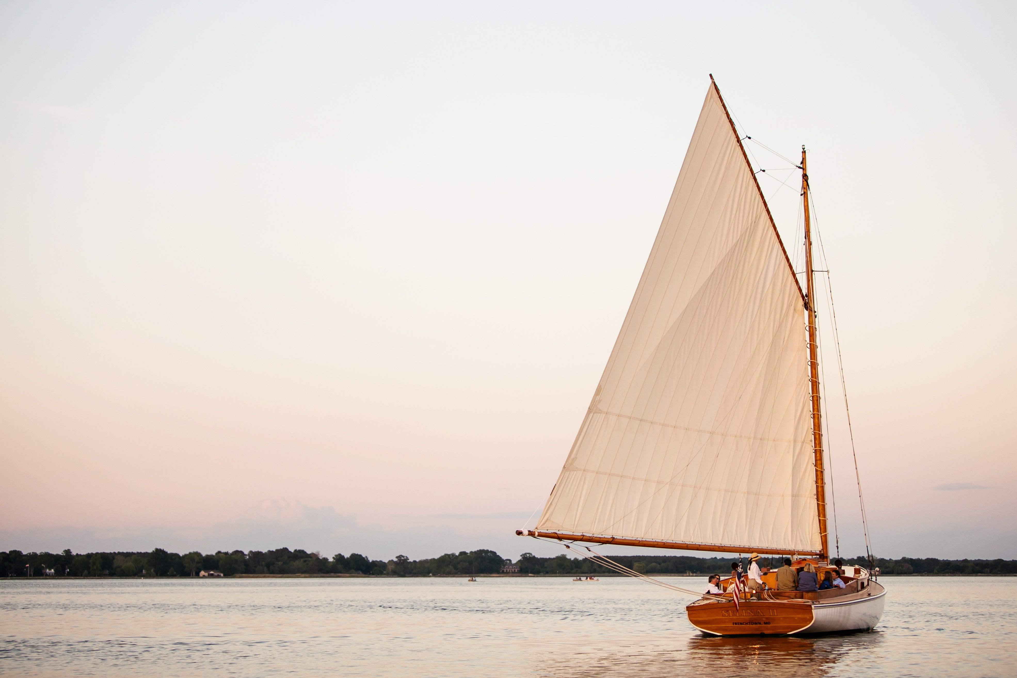The Selina II sailing away at sunset