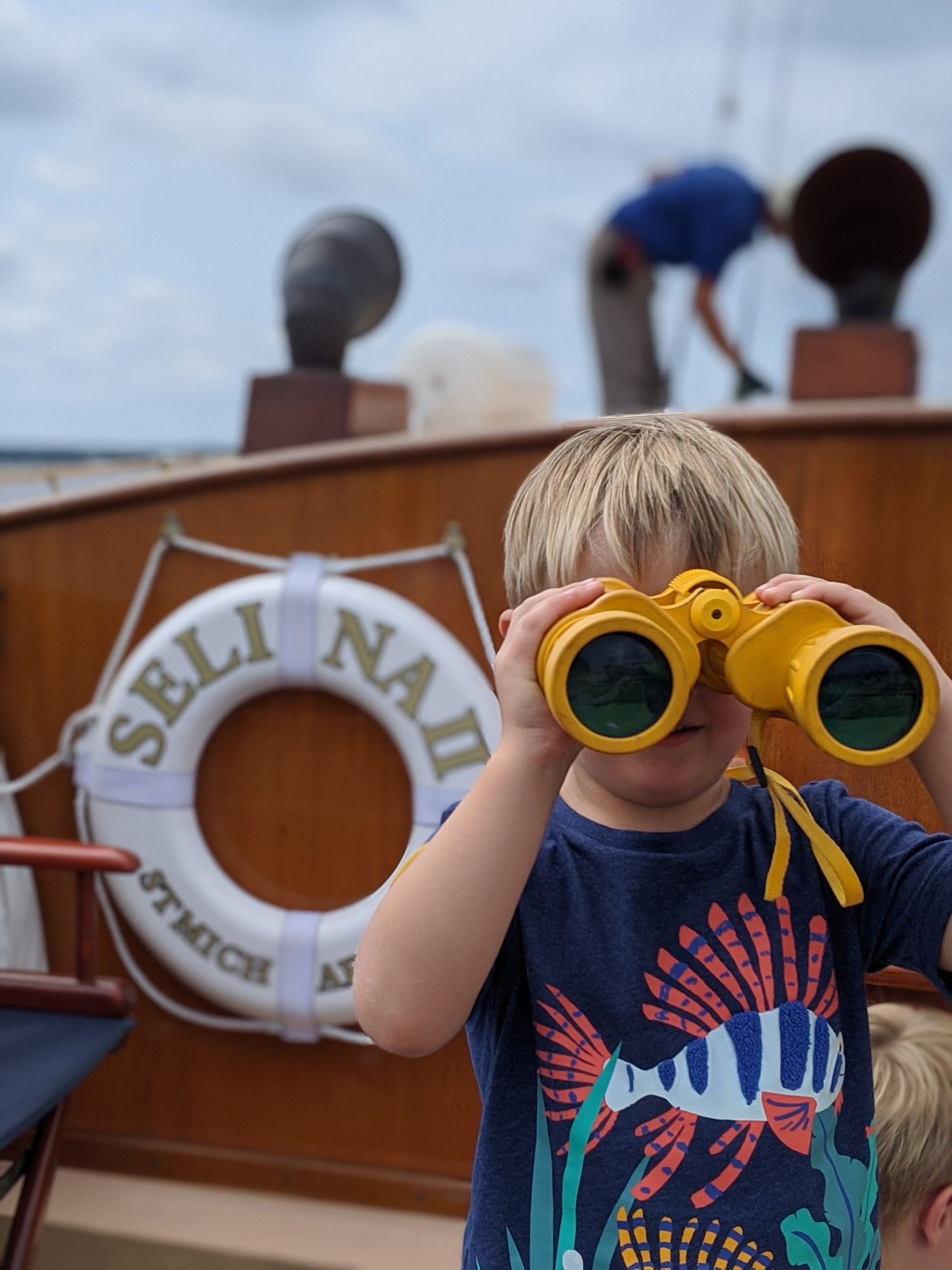 little kid on boat looking curious