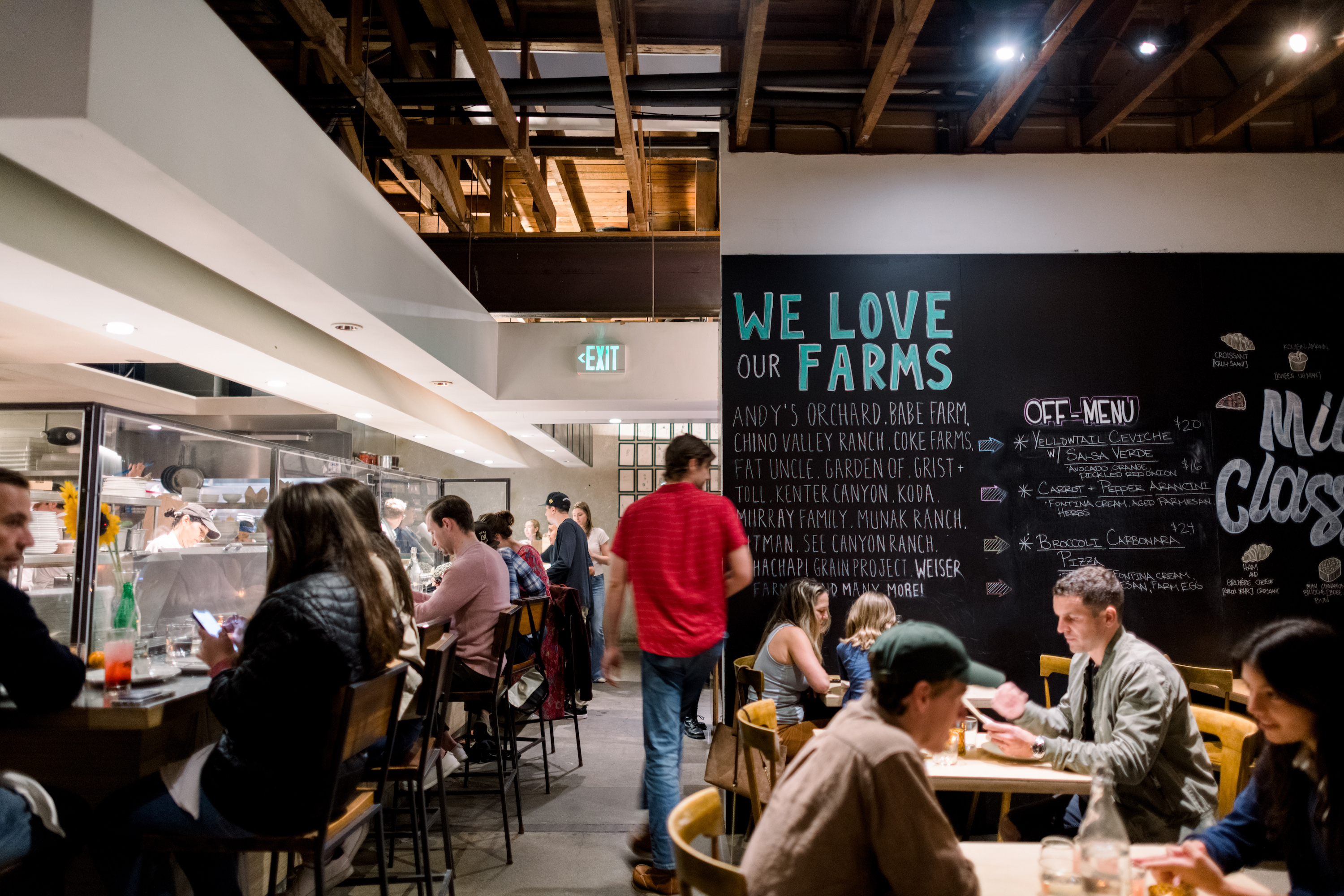 Guests dining at the chef's counter and in the back dining room