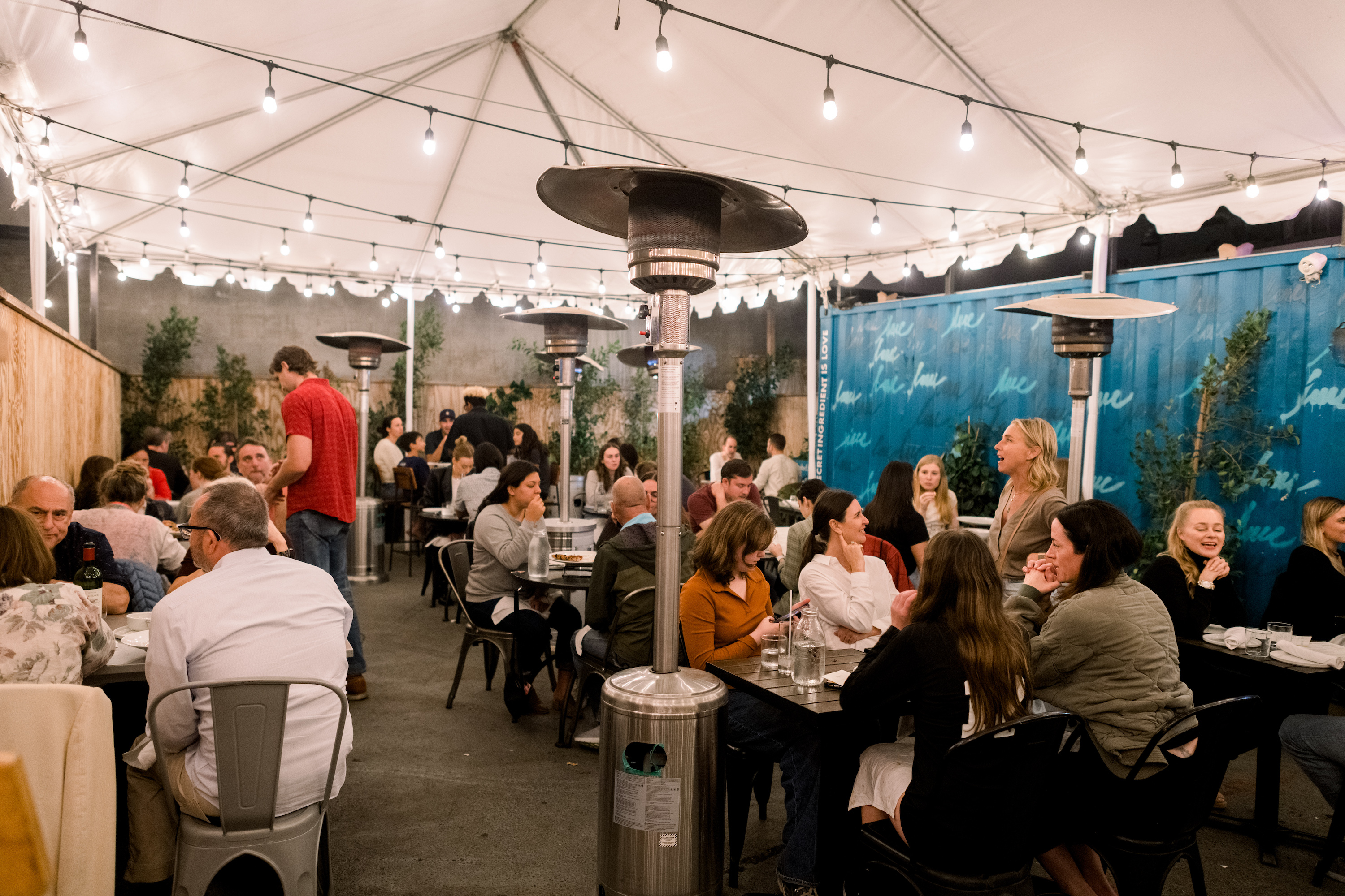Guests dining on the covered back patio