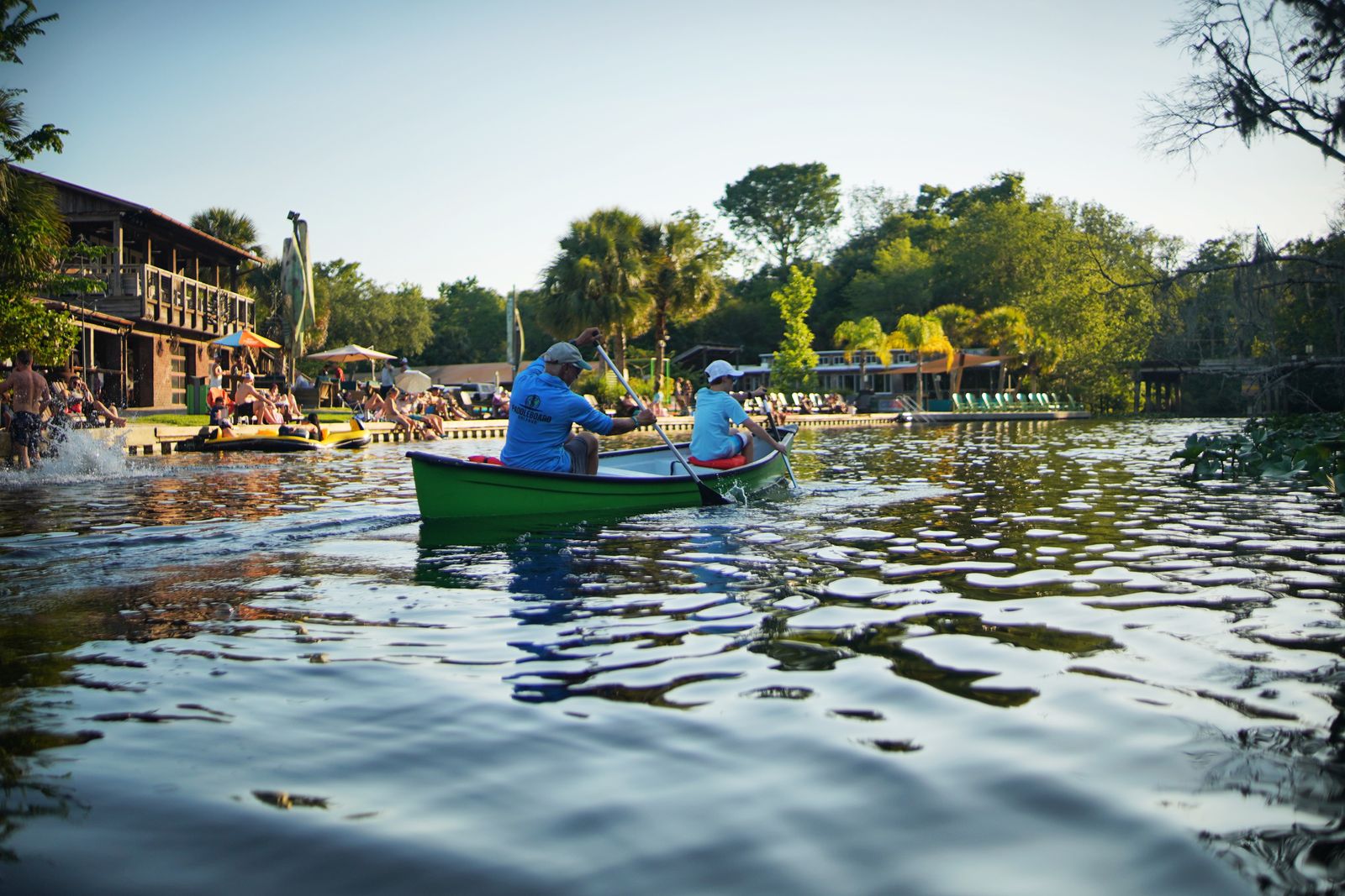 Visitors paddling a green canoe along the Wekiva River near Wekiva Island