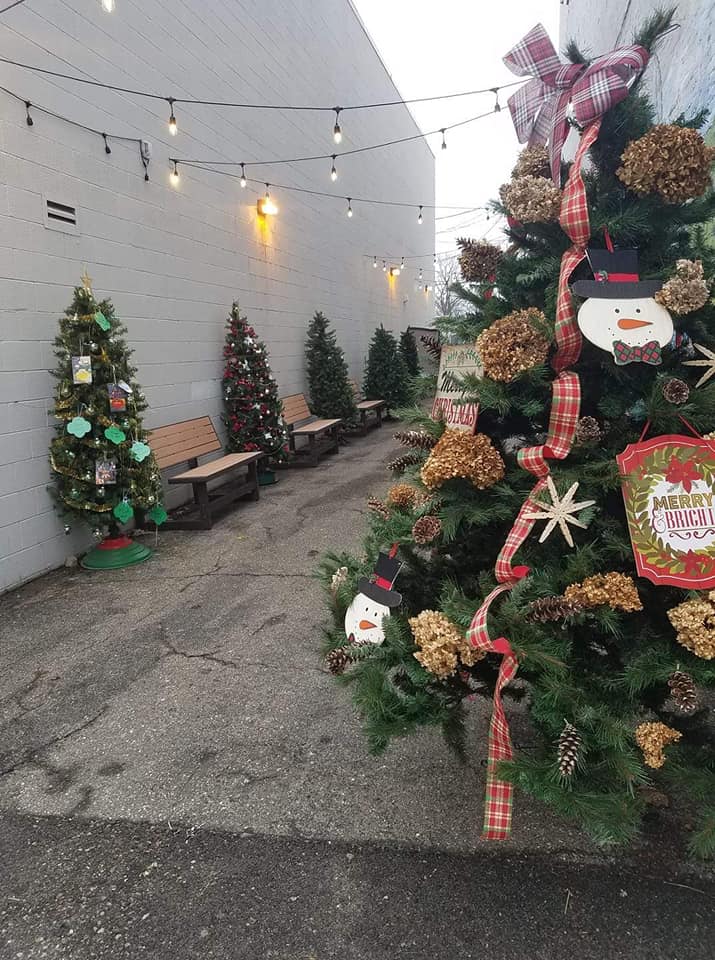 Decorated Christmas trees are displayed in an alleyway at Manchester Christmas in the Village