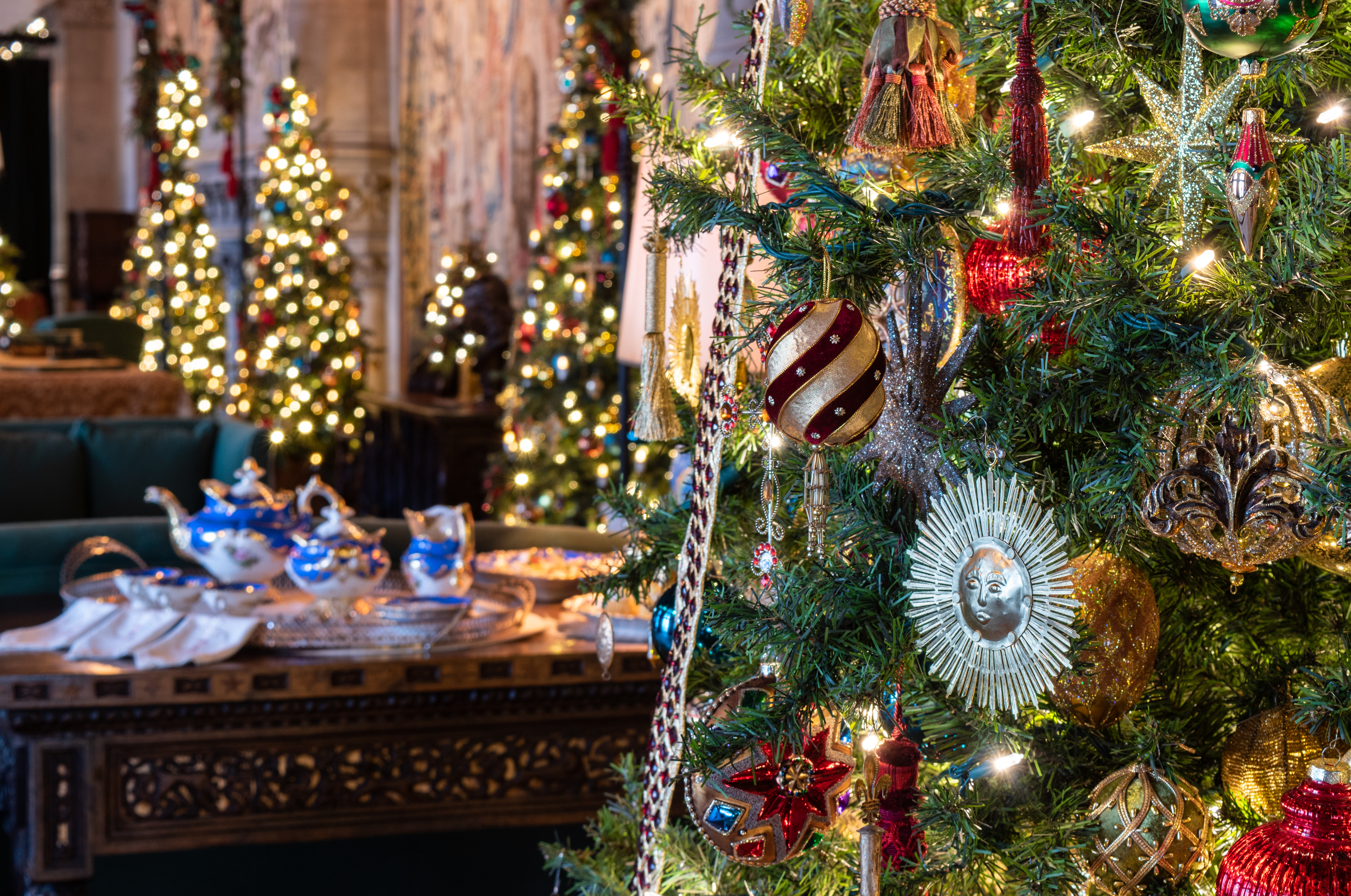 Gorgeous ornaments decorate the trees in the Tapestry Gallery during Christmas at Biltmore