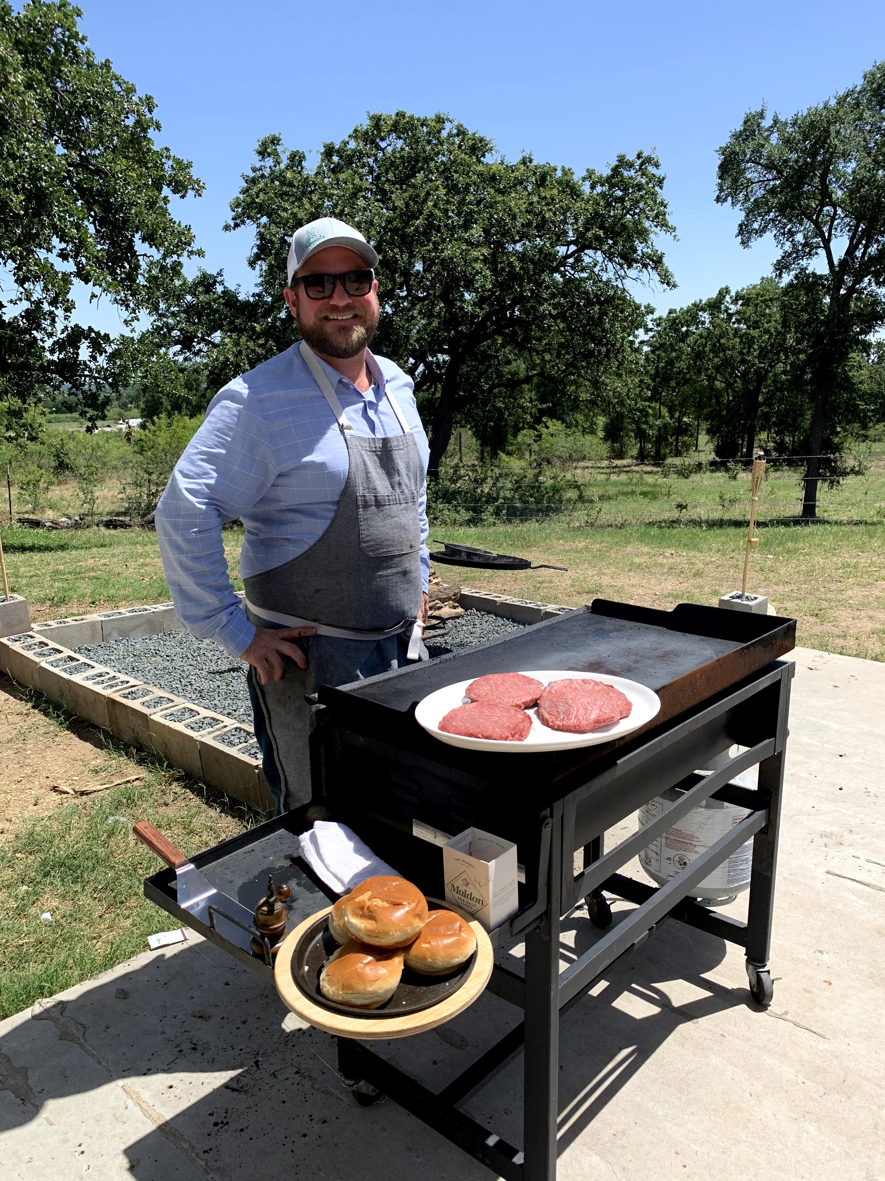 Chef Drew Curren of 24 Diner cooking hamburgers at the grill in Austin TExas
