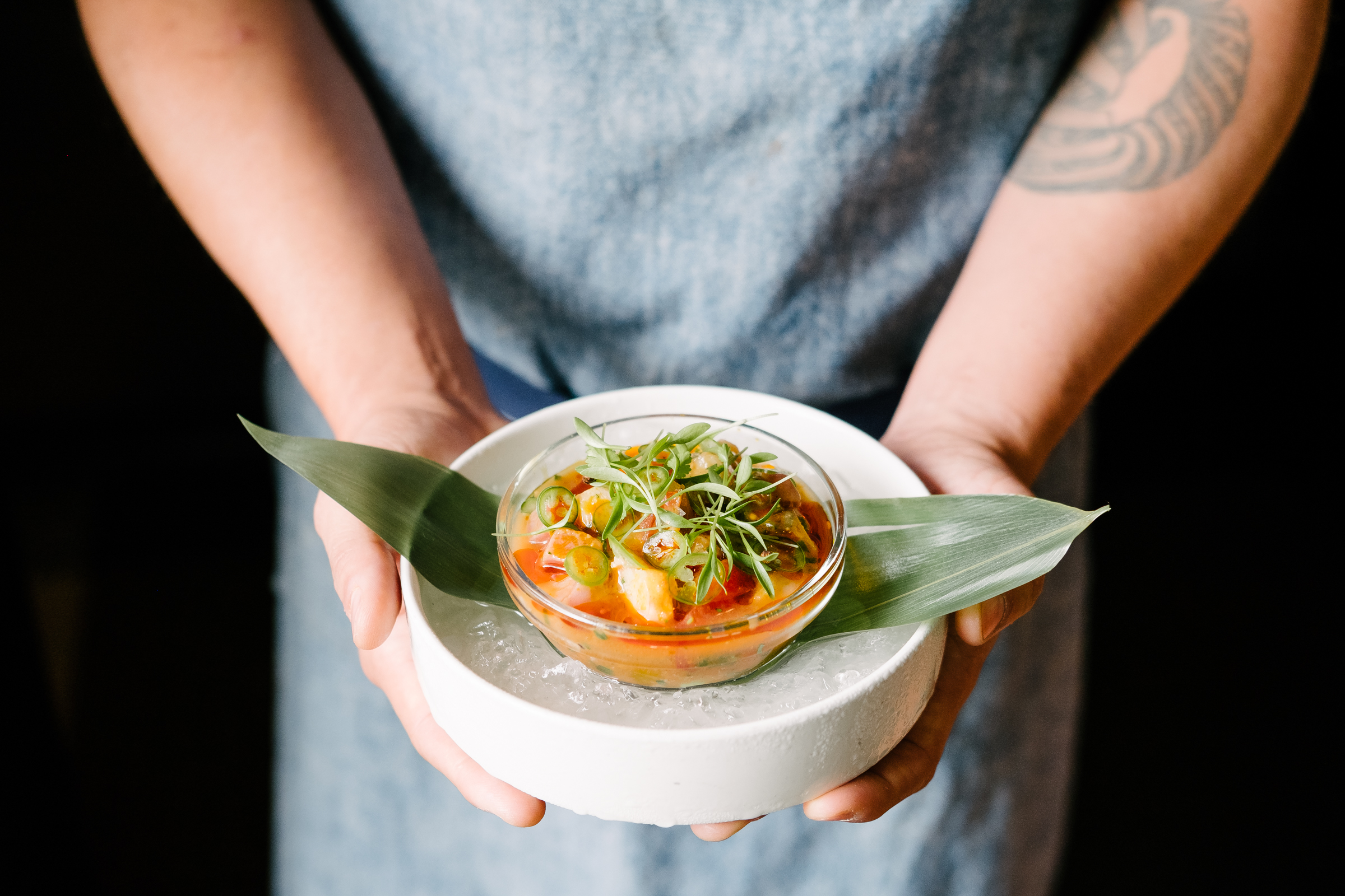 Person holds bowl of ceviche from La Condesa in Austin Texas