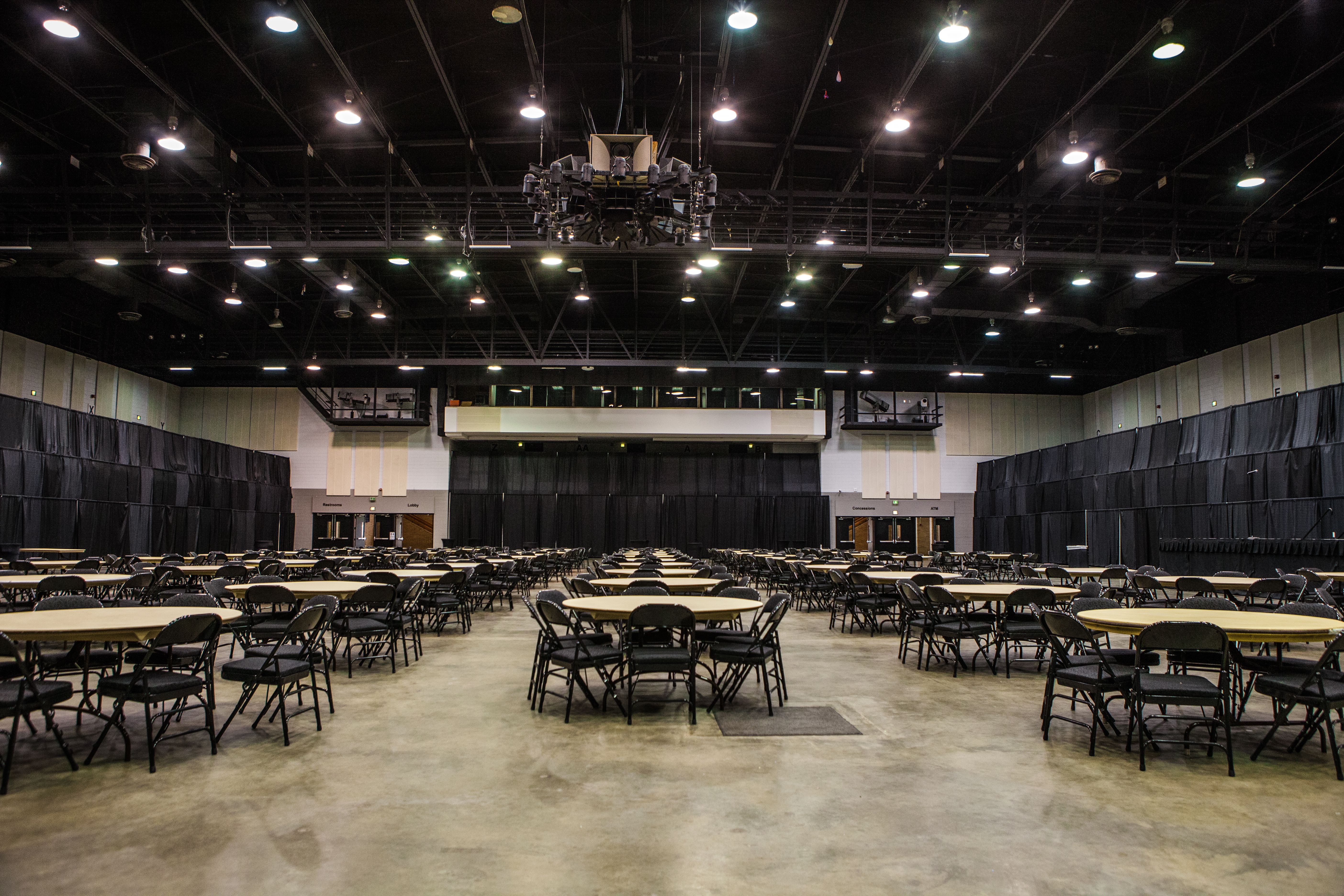 Empty Meeting Hall With Tables And Chairs And A Stage