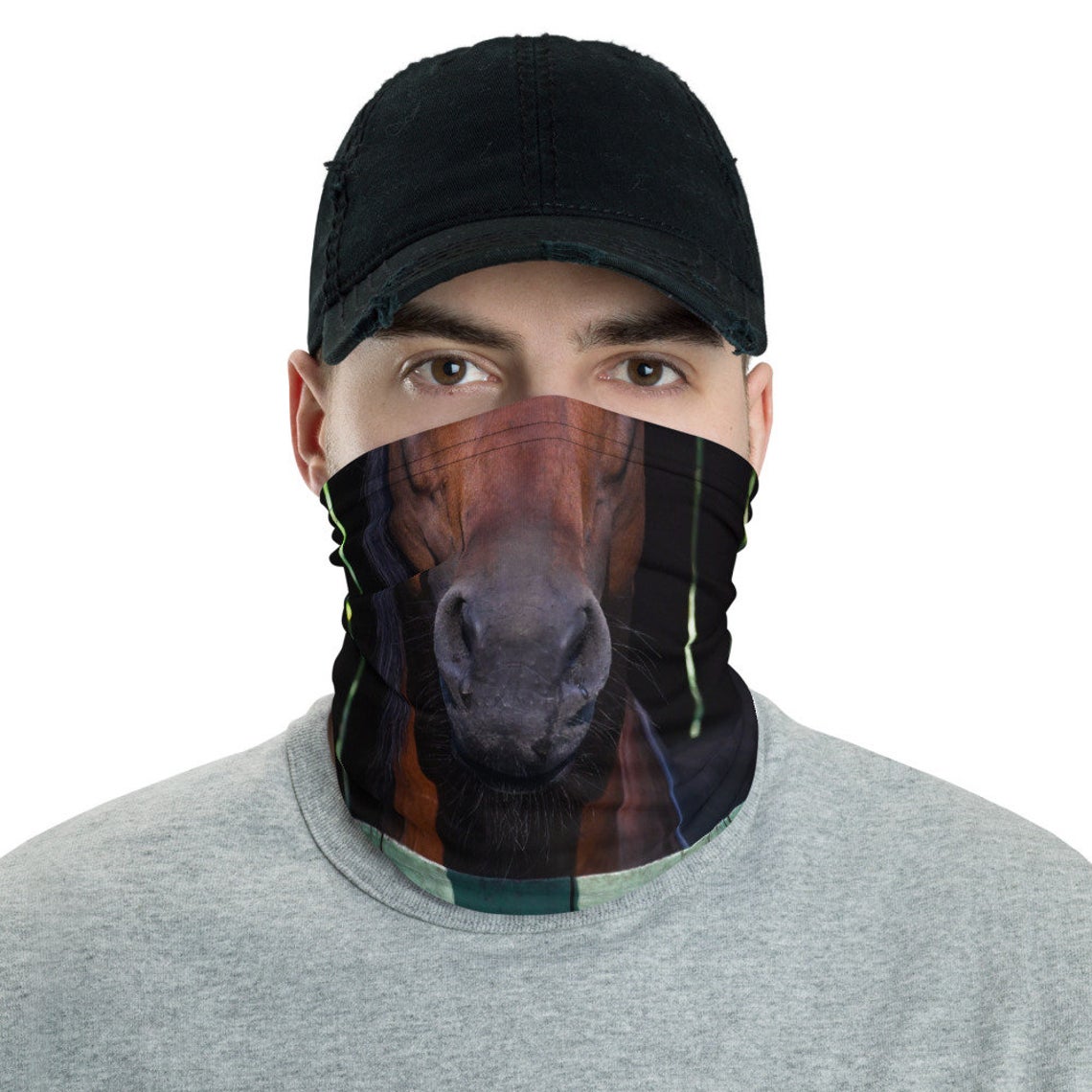 Man in black hat models a gaiter printed with the snout of a brown horse