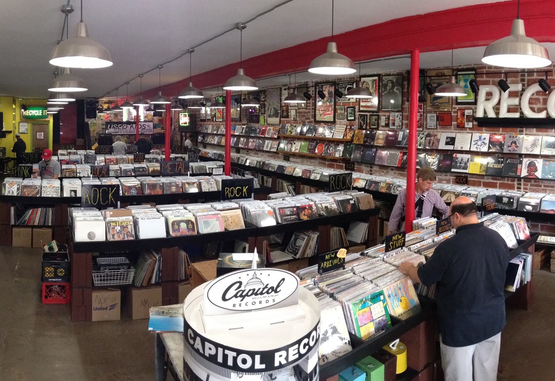 View of aisles and shoppers inside Used Kids record store