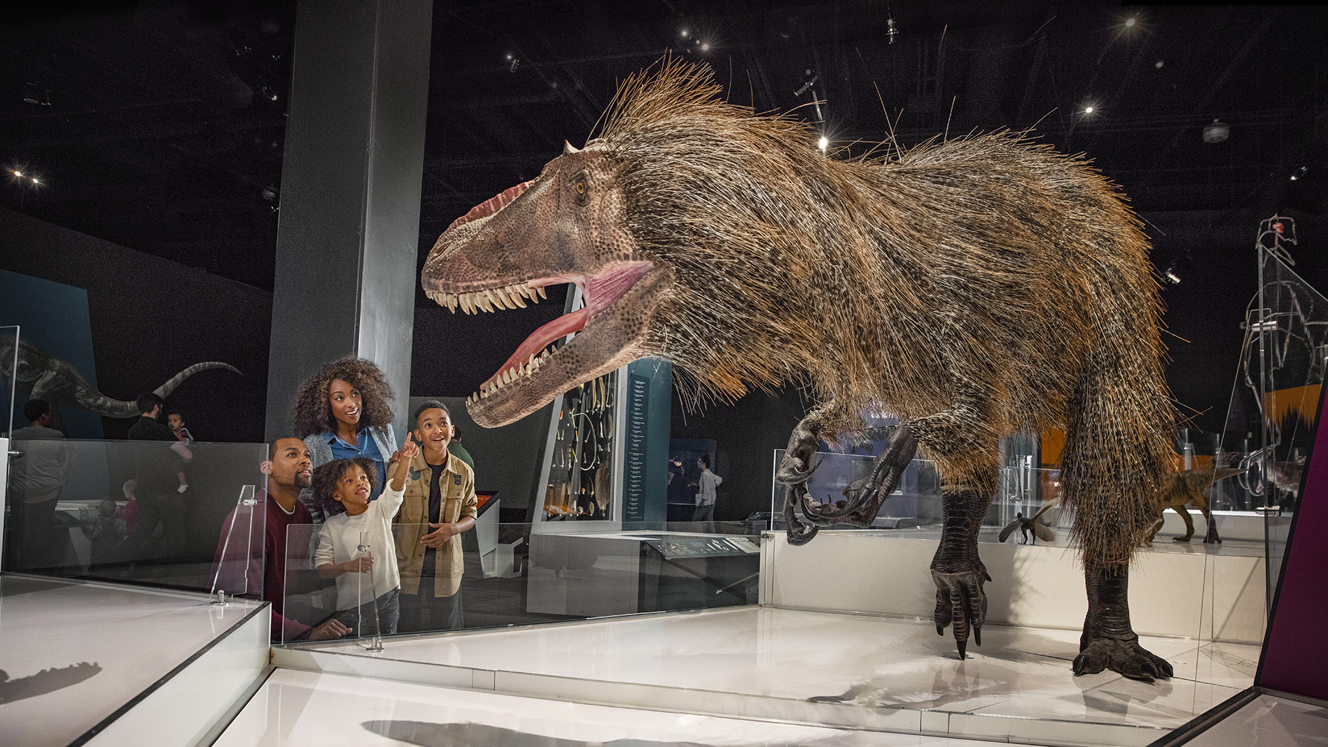 Family admiring life-size dinosaur at COSI
