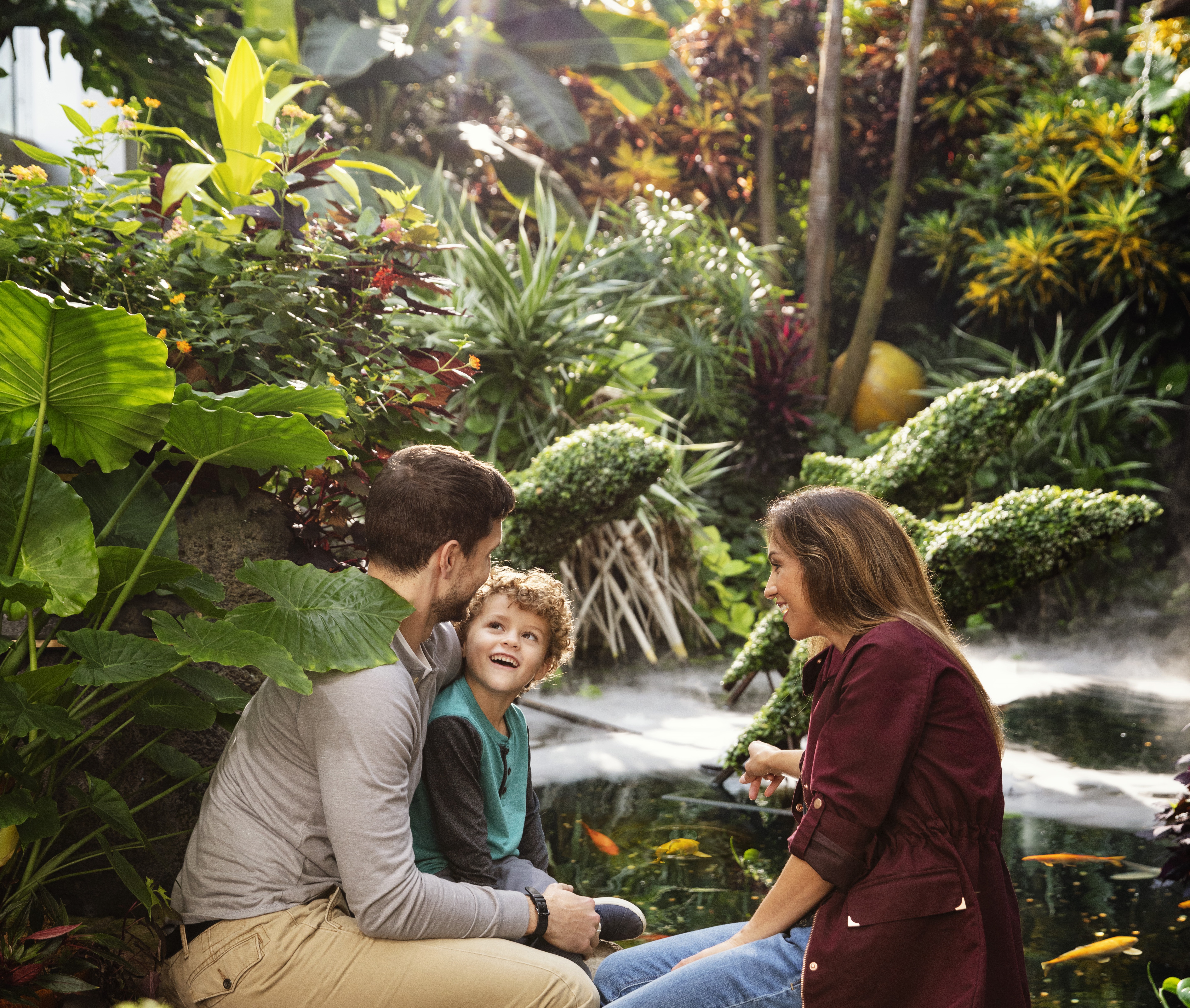 Family with small child admiring plant life inside the Franklin Park Conservatory and Botanical Gardens