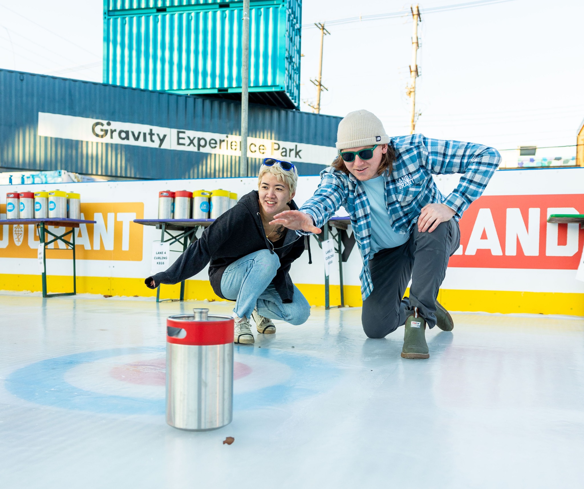 Two people ice keg curling at Land-Grant
