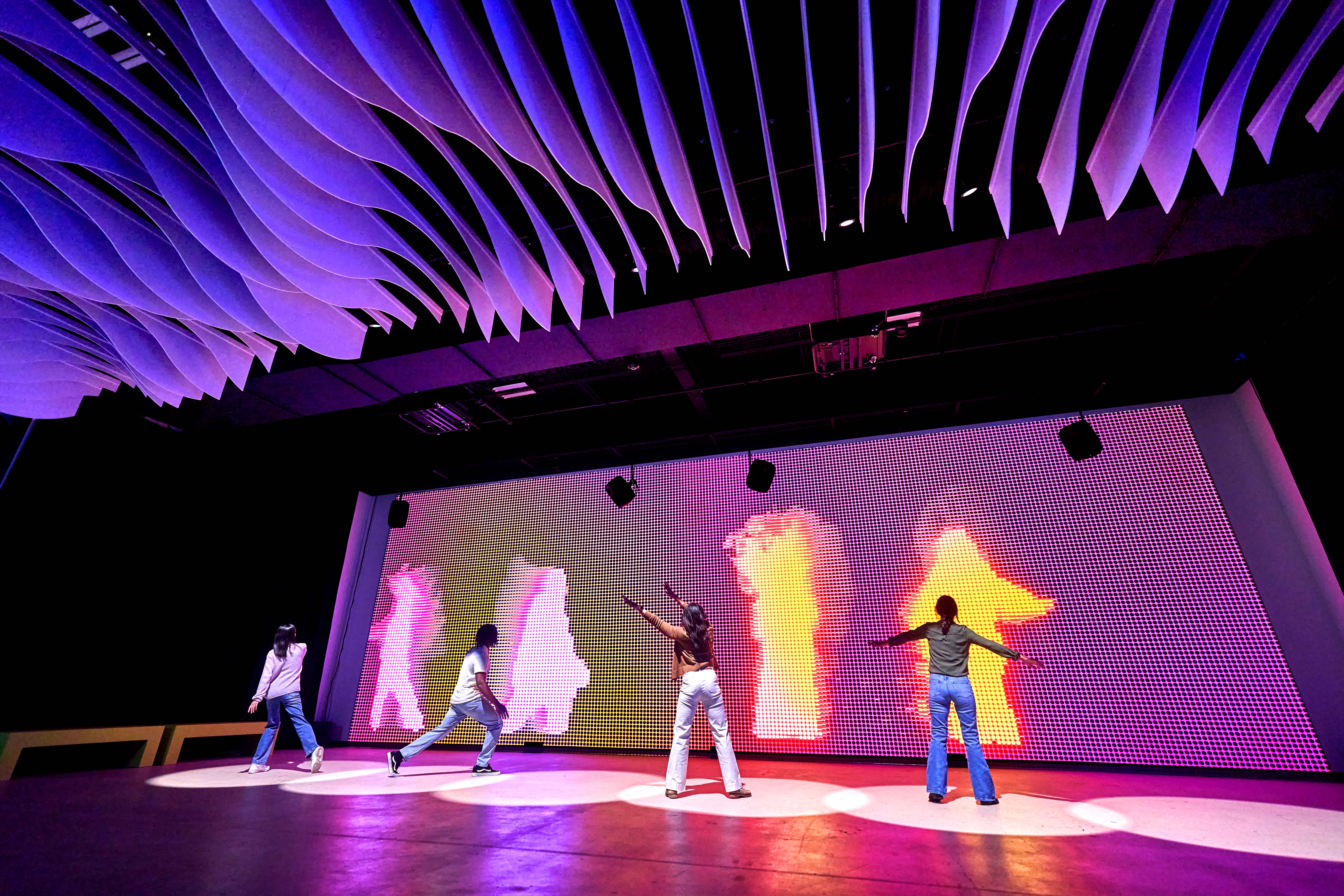 Group of people interacting with exhibit inside Prototype Museum