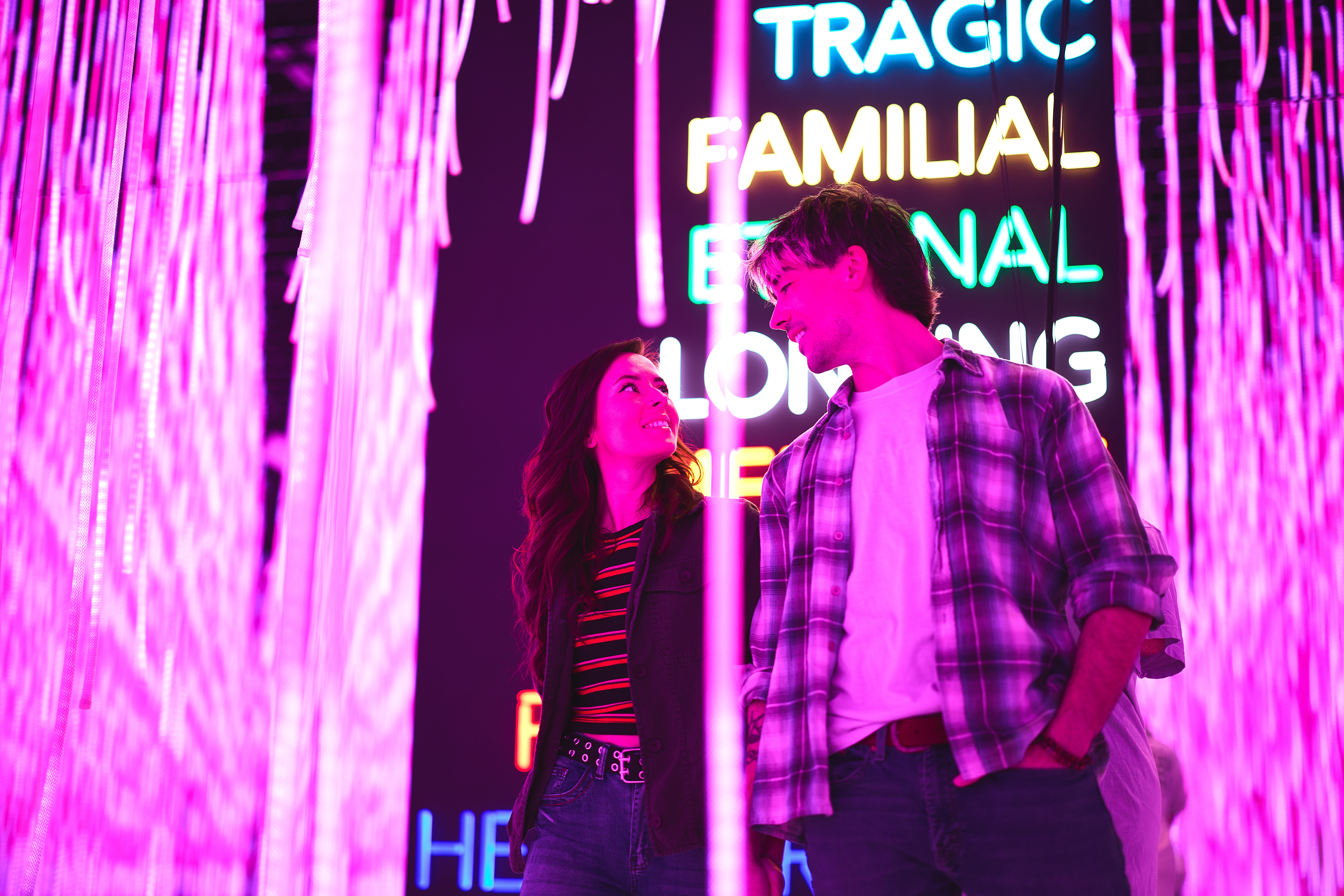 A couple interacting with the Love Hug exhibit in Prototype Museum