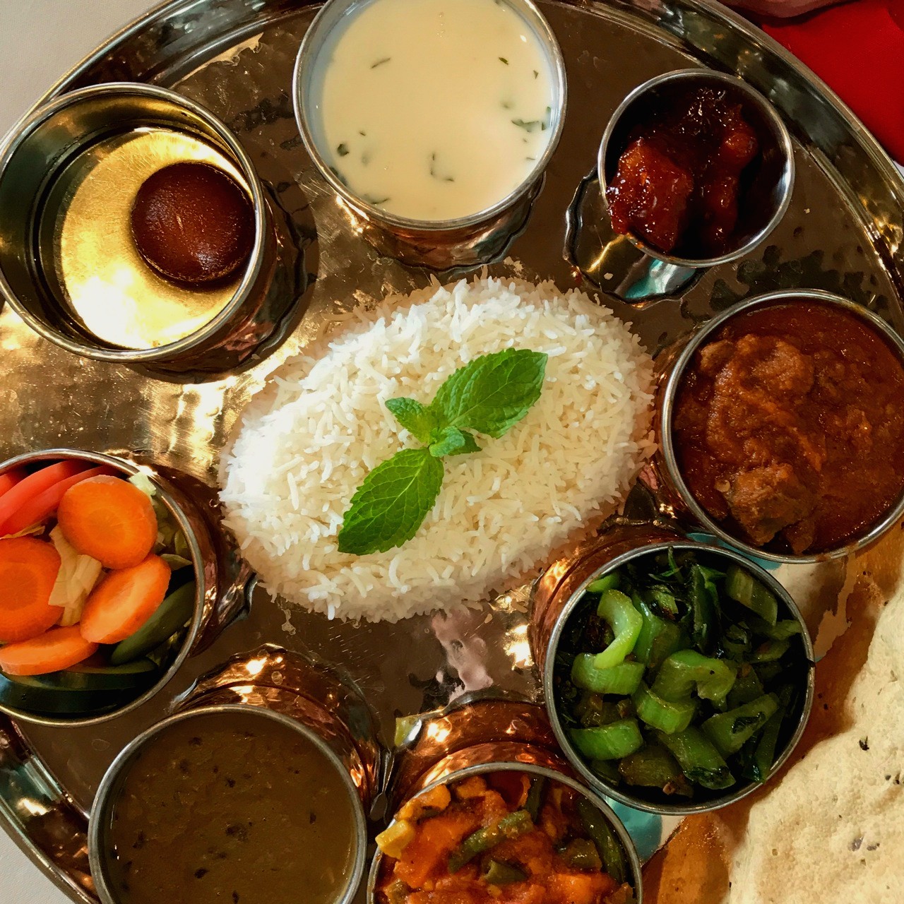 View of rice and various toppings on silver platter at Everest restaurant