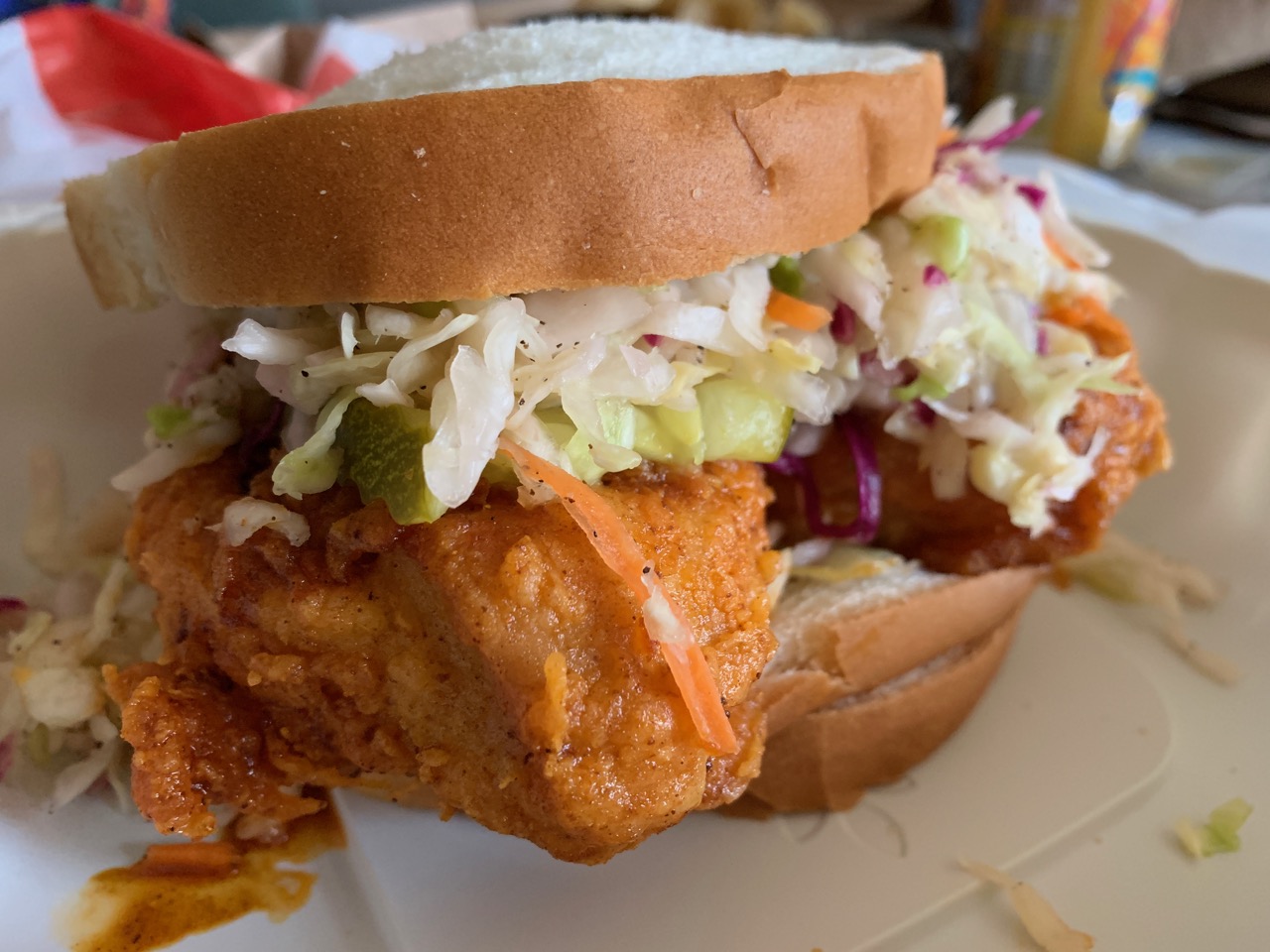Sandwich topped with fried chicken and cole slaw from Hot Chicken Takeover