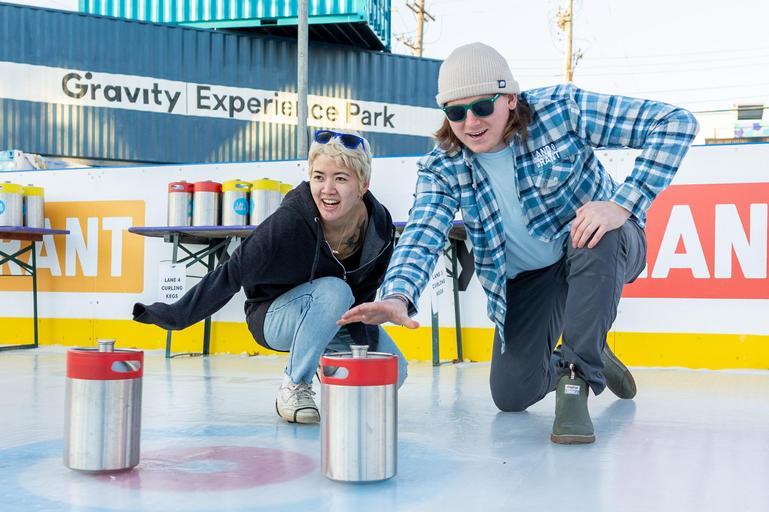 Two people ice keg curling at Land-Grant