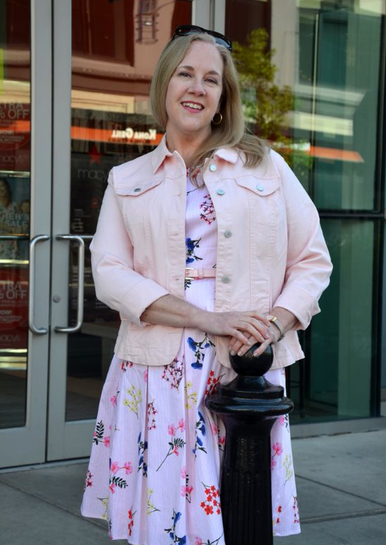 Woman shopping at Easton wearing floral sundress and denim jacket