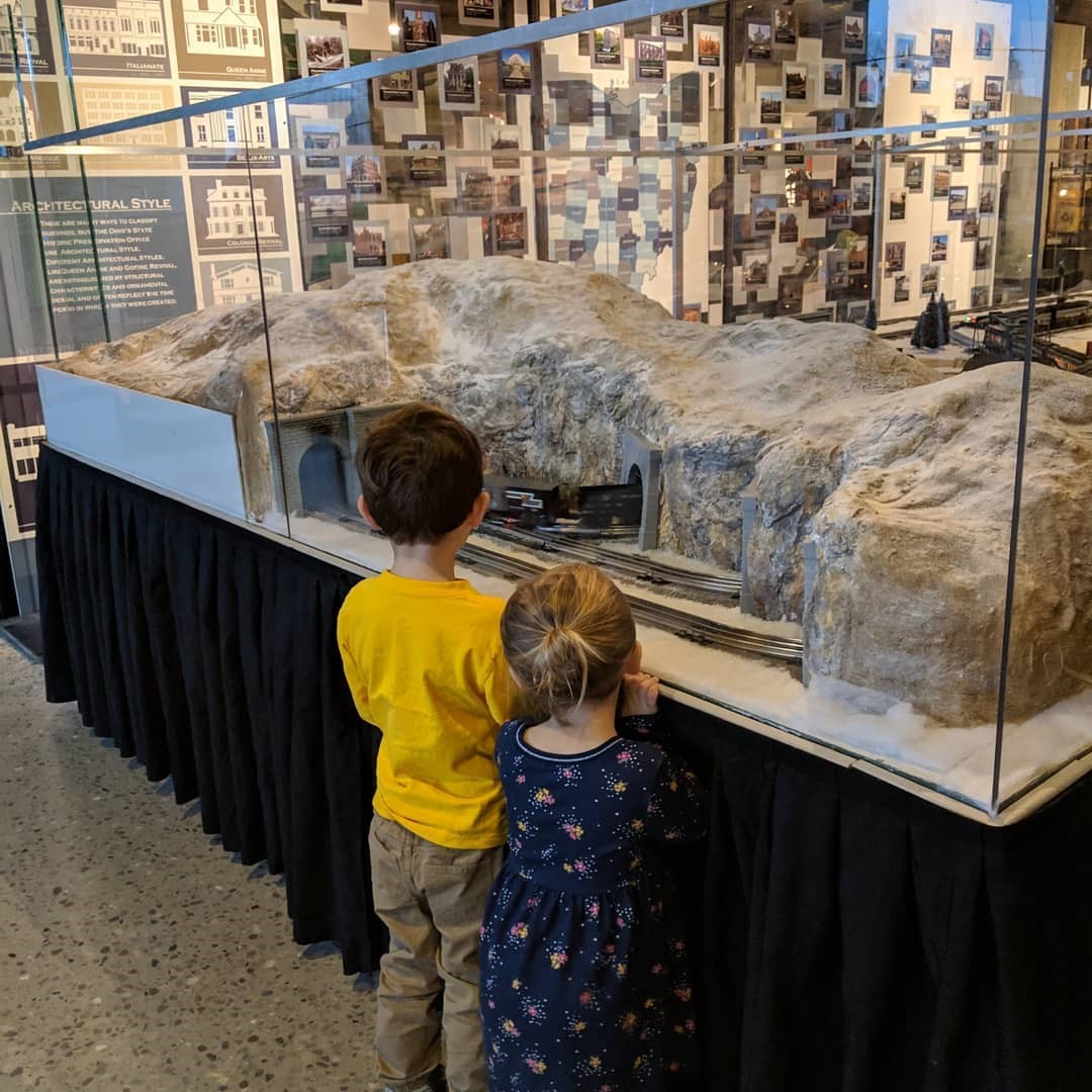 A young boy and girl looking through the glass at an exhibit at the Ohio History Center.