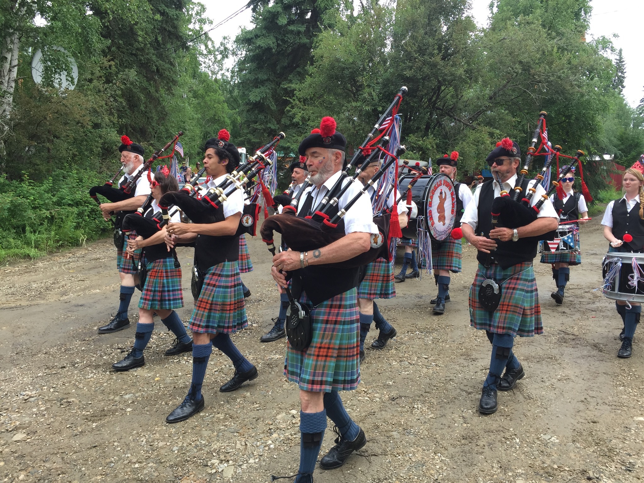 Bag pipers dressed in Scottish kilts playing in formation