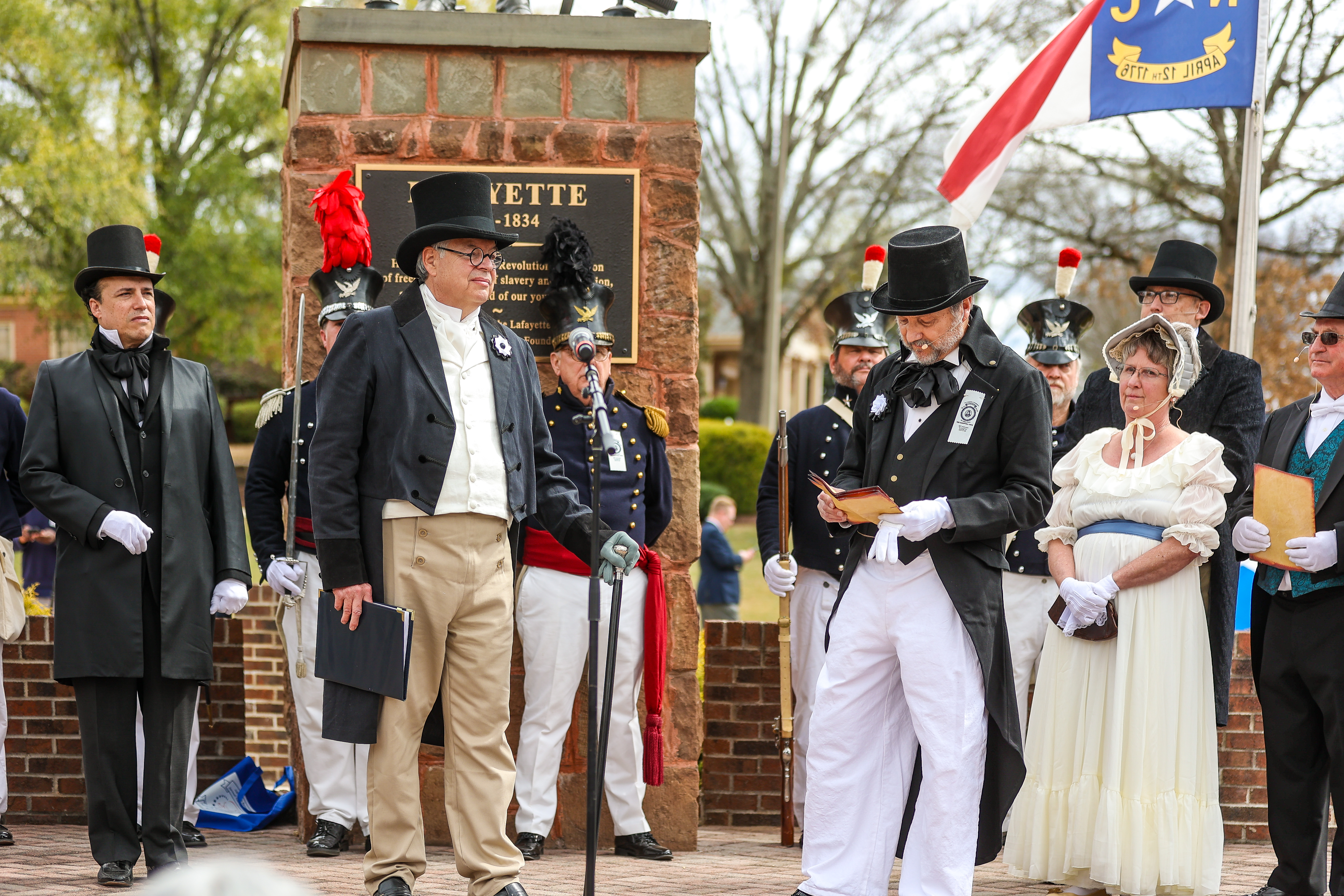 Historical reenactors in 1800s attire perform at the Lafayette statue in downtown Fayetteville, NC, during the city’s anniversary celebration honoring the Marquis de Lafayette.