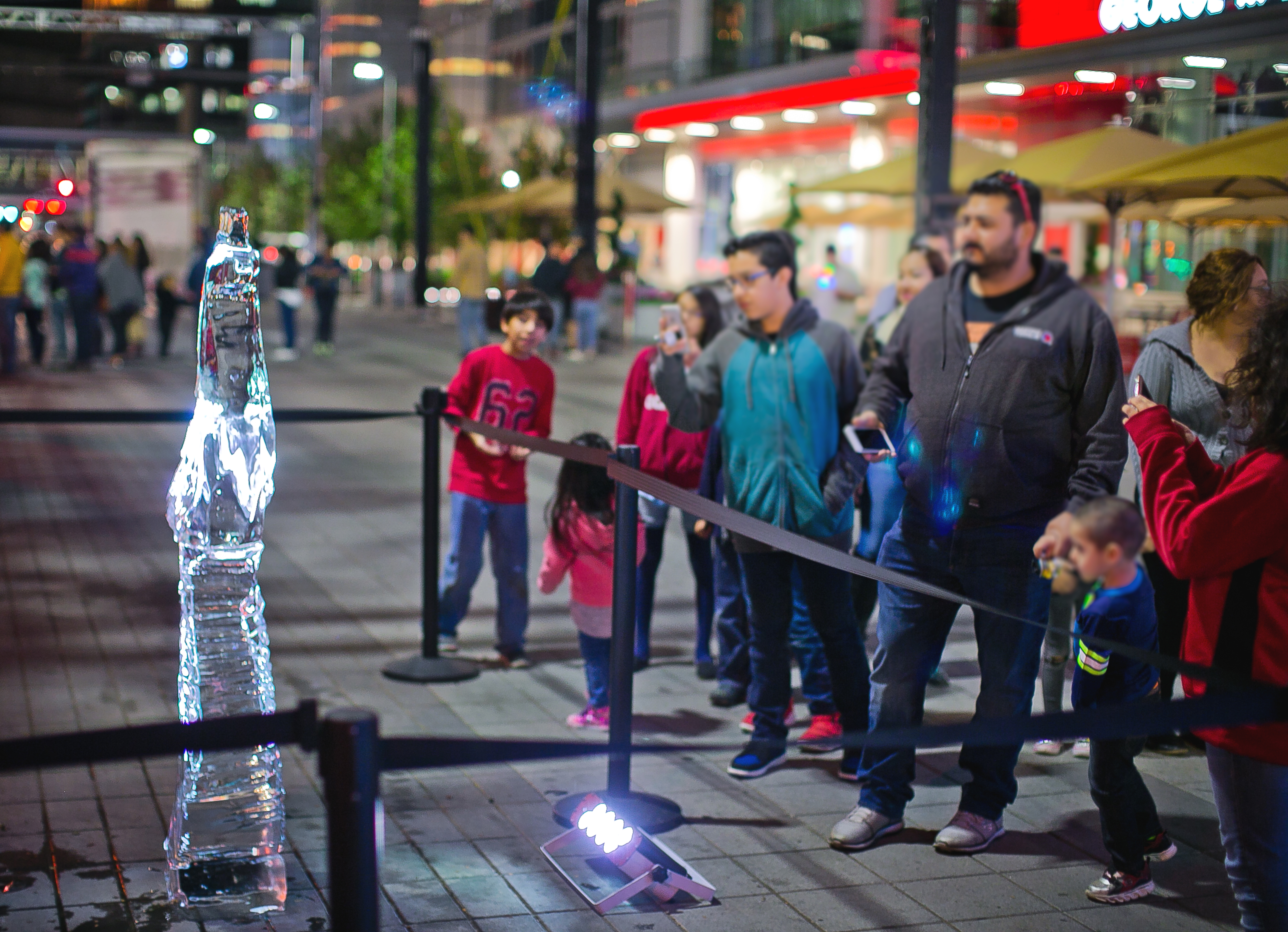 Visitors enjoy an ice sculpture during Frostival at Discovery Green